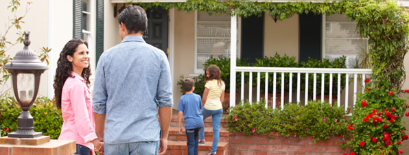 Couple walking into their home.